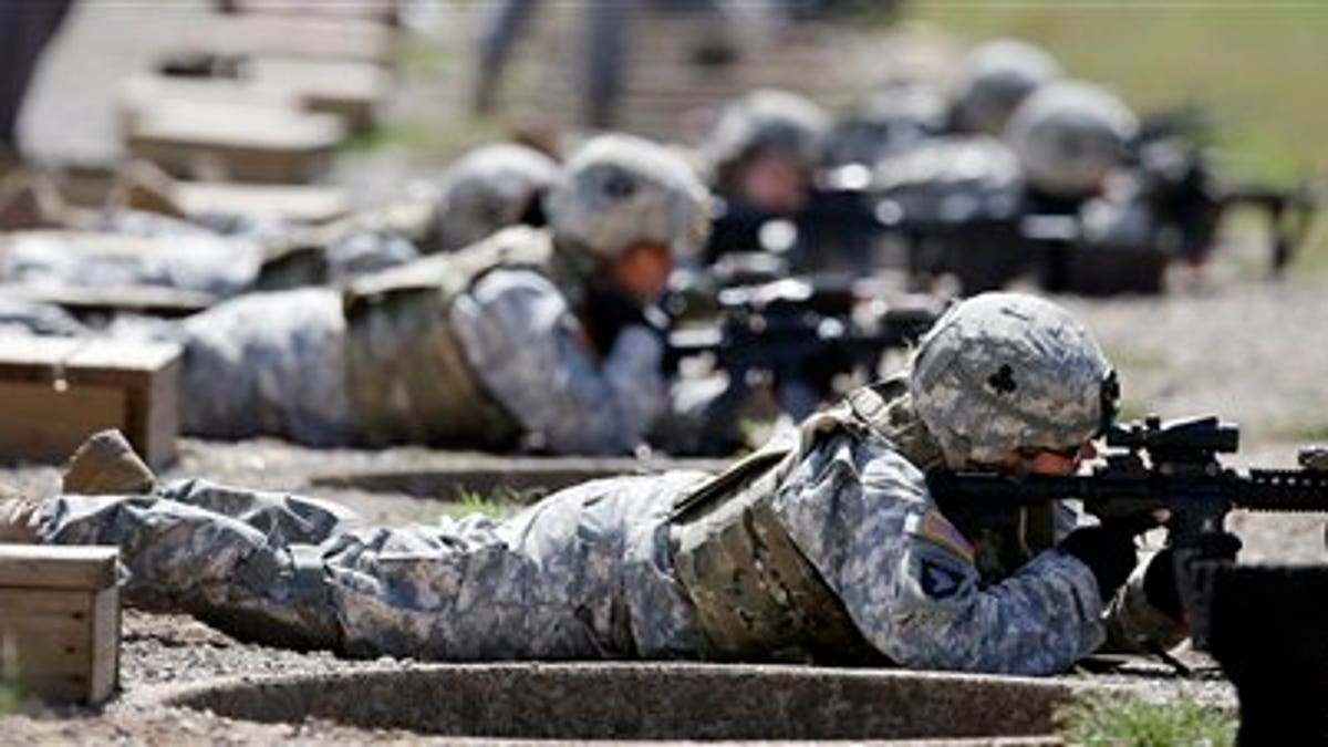 FILE - This Sept. 18, 2012 file photo shows female soldiers training on a firing range while wearing new body armor in Fort Campbell, Ky. Only a small fraction of Army women say theyd like to move into one of the newly opening combat jobs, but those few who do, say they want a job that takes them right into the heart of battle, according to preliminary results from a survey of the services nearly 170,000 women. (AP Photo/Mark Humphrey, File)