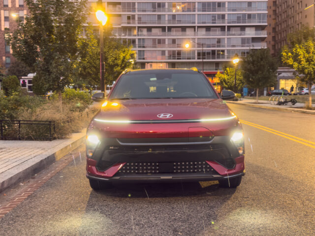 A Hyundai Kona Electric seen head-on, with some raindrops streaking past the camera