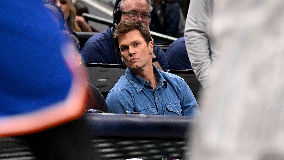 Tom Brady looks on NBA court