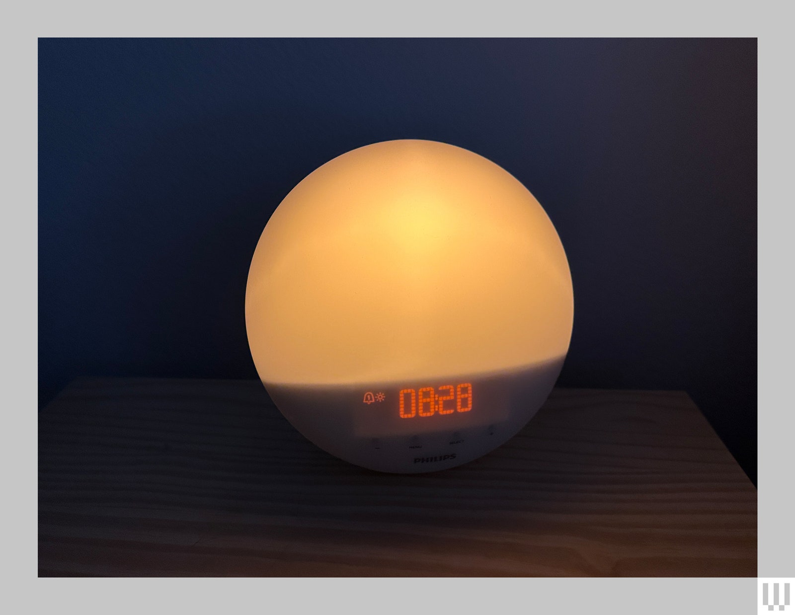 Circular alarm clock with illuminated top and small digital display below