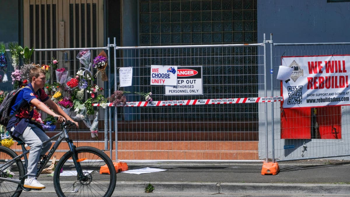 cyclist passes synagogue