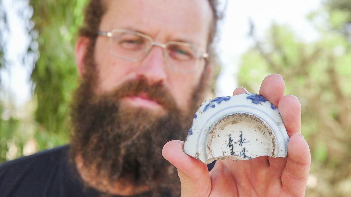 Man holding Chinese bowl