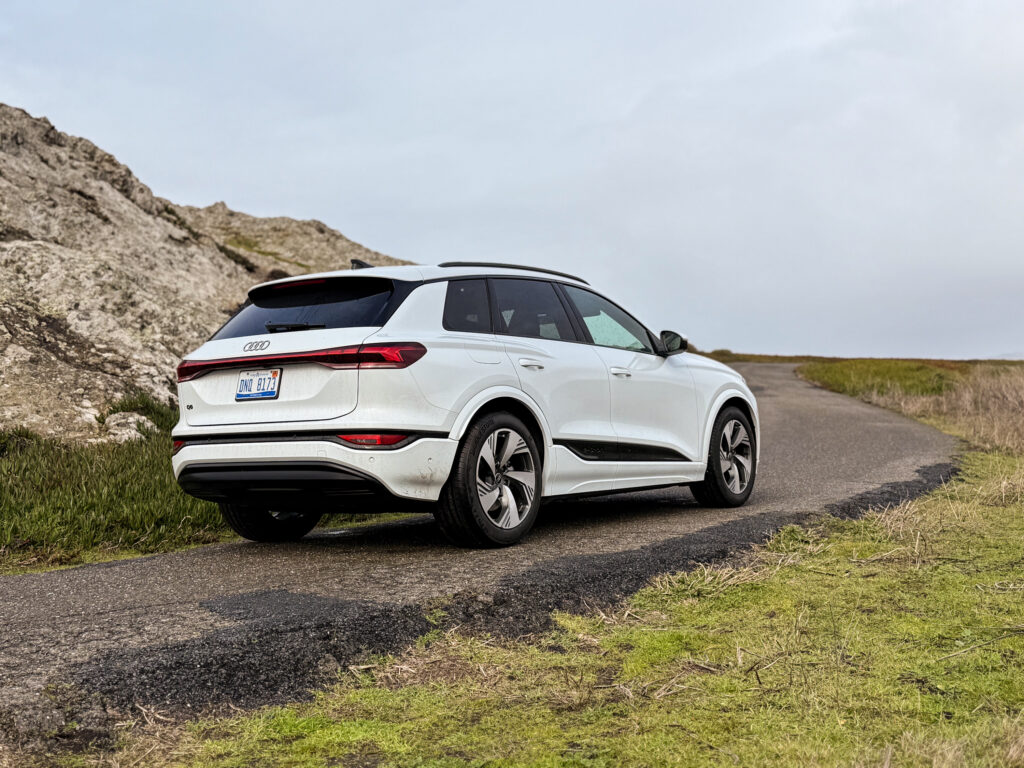 A white Audi Q6 seen from the rear 3/4s