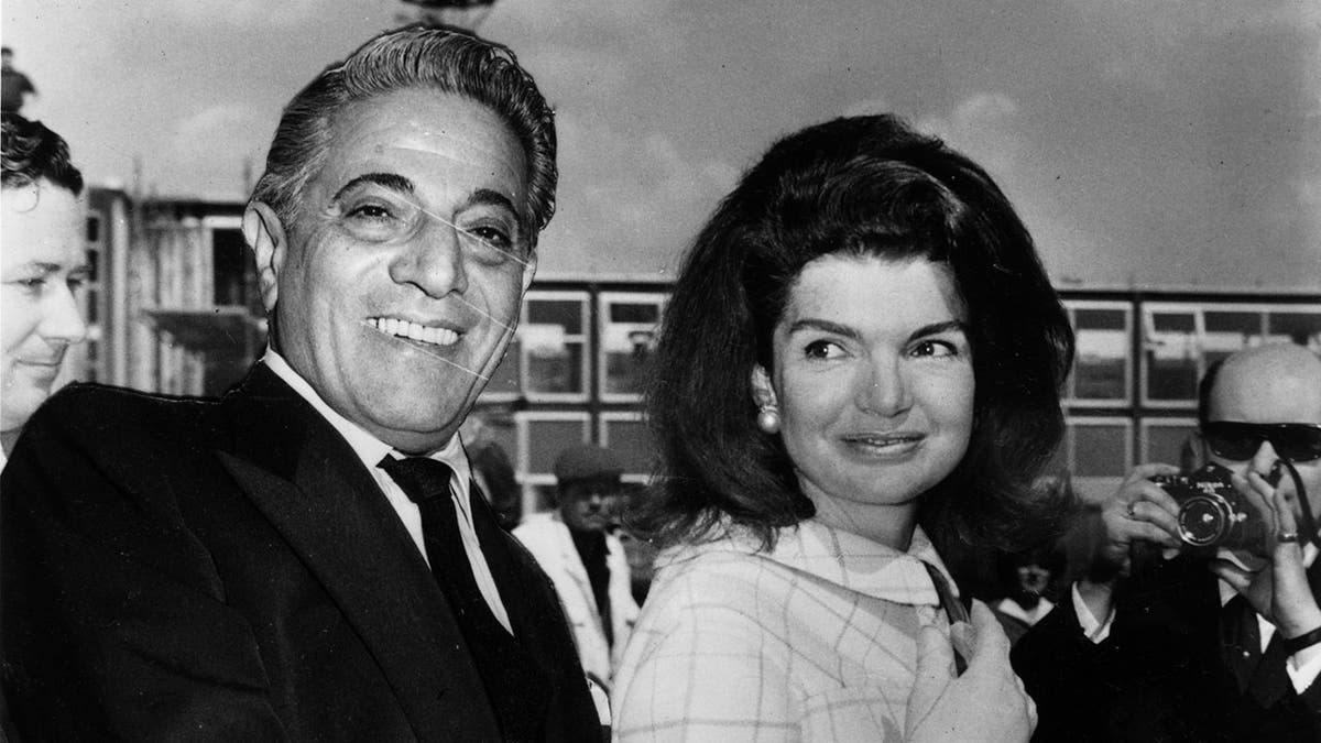 Aristotle Onassis smiling next to Jackie Kennedy