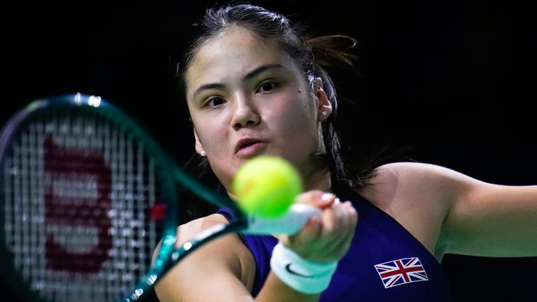 Great Britain's Emma Raducanu returns the ball to Slovakia's Viktoria Hruncakova during a Billie Jean King Cup semi-final match at Martin Carpena Sports Hall in Malaga, southern Spain, on Tuesday, Nov. 19, 2024. (AP Photo/Manu Fernandez)