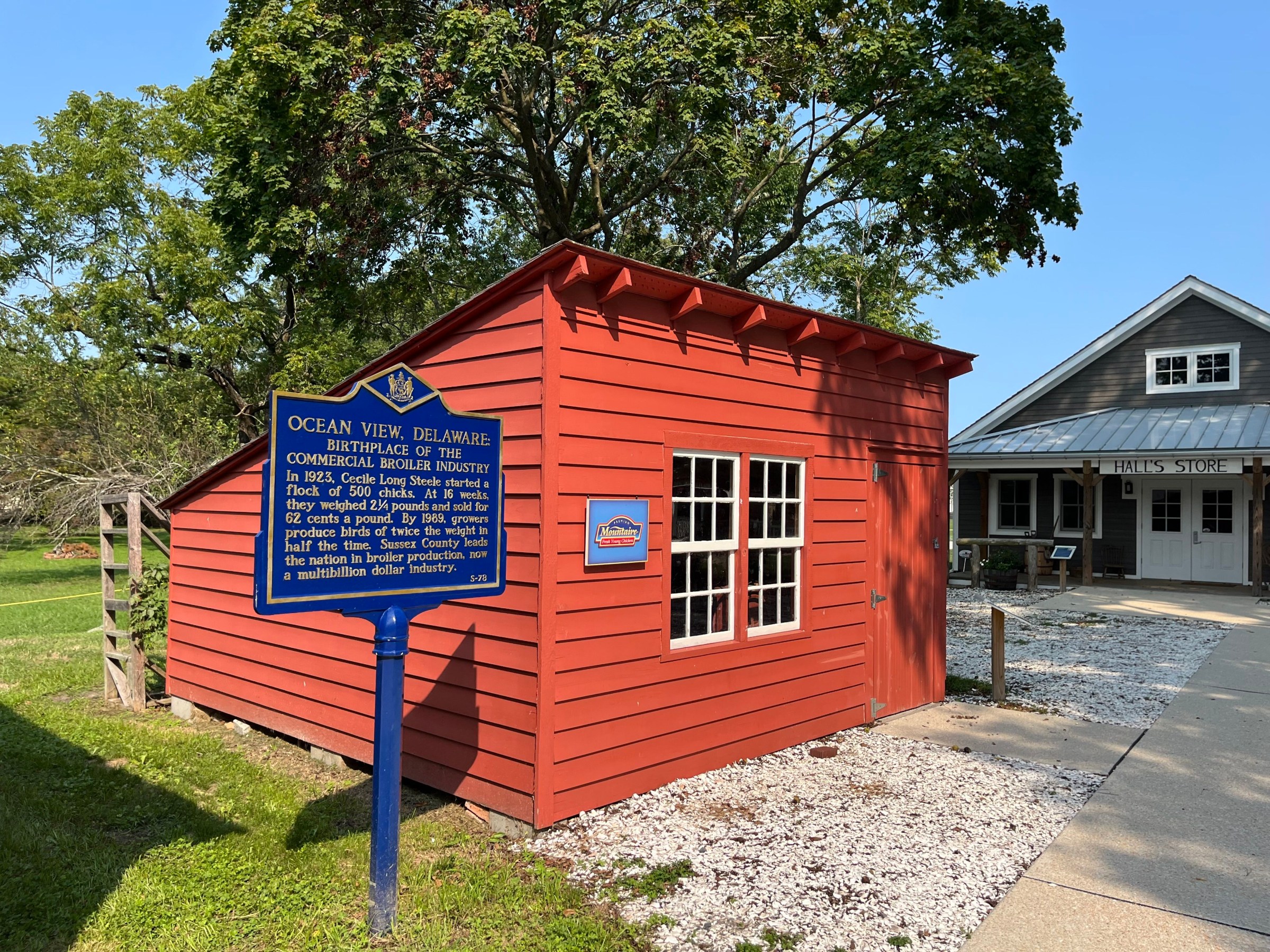 A red 256-square foot barn with a plaque on the side that tells Cecile Steele’s story.