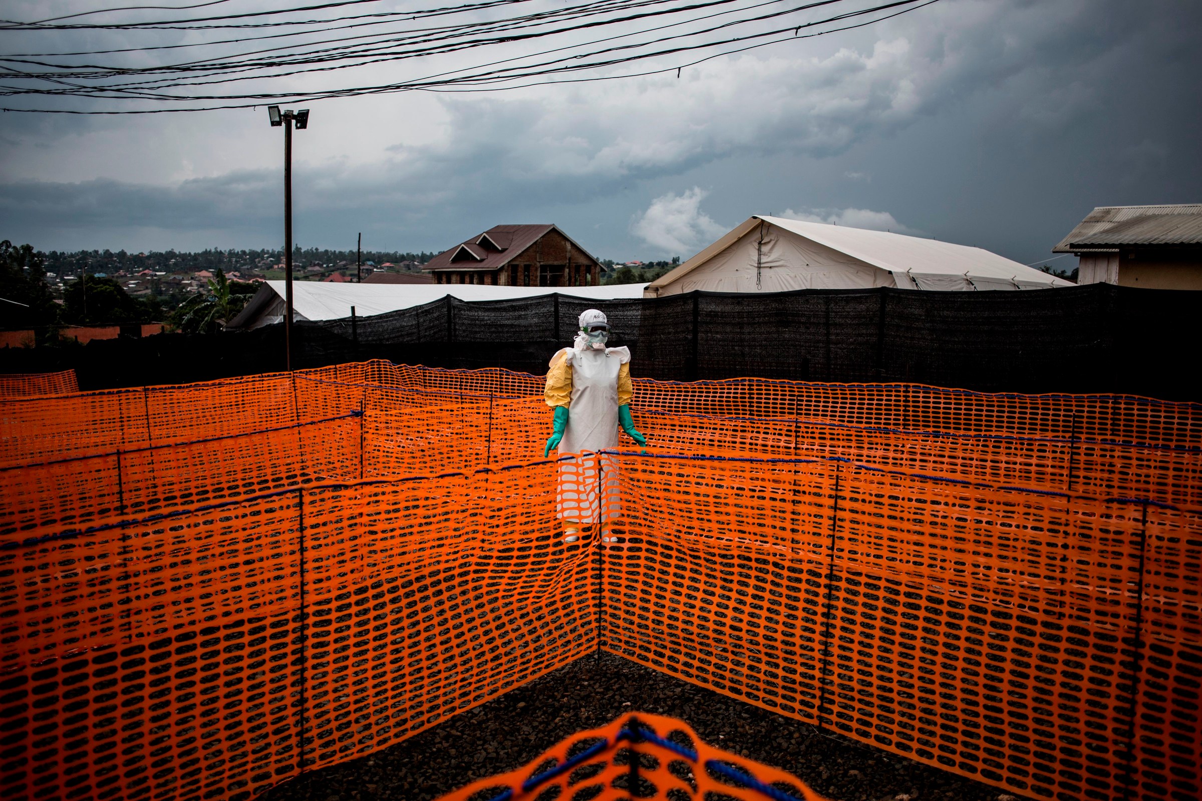 A health worker waits to handle a new unconfirmed Ebola patient 