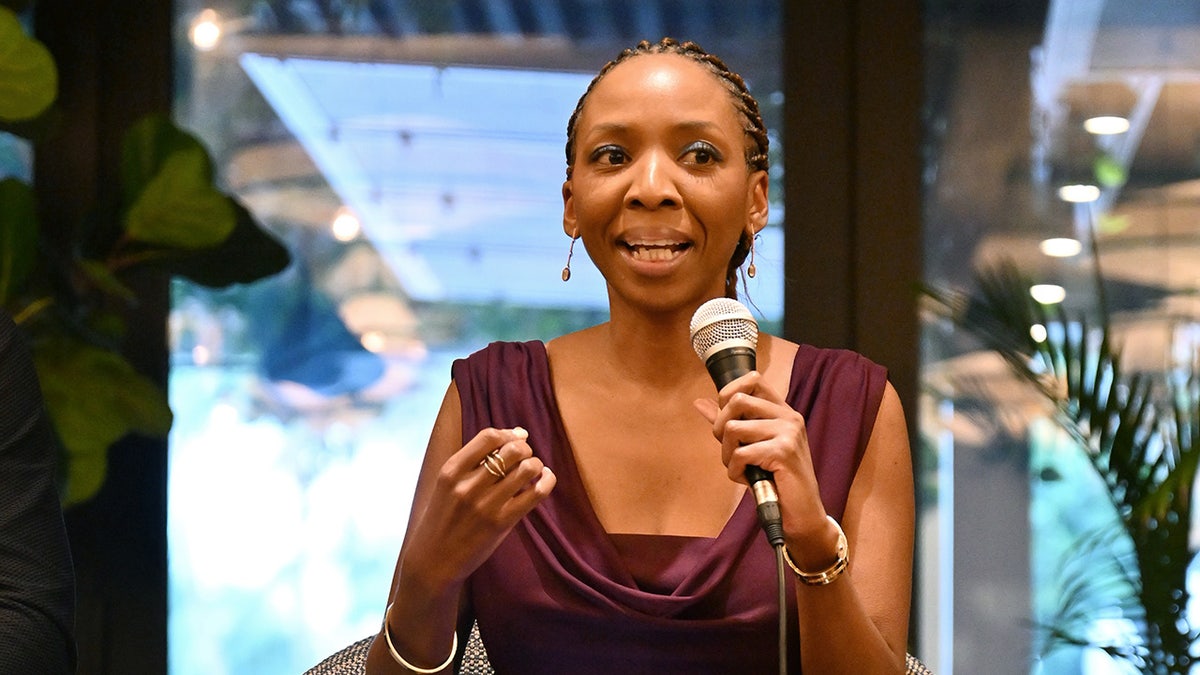 Dr. Sophie Chandauka speaking into microphone