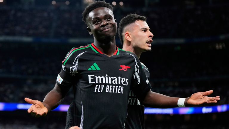 Arsenal's Bukayo Saka celebrates after scoring the opening goal during the Champions League quarterfinals second leg soccer match between Real Madrid and Arsenal at the Santiago Bernabeu stadium in Madrid, Wednesday, April 16, 2025. (AP Photo/Manu Fernandez)
