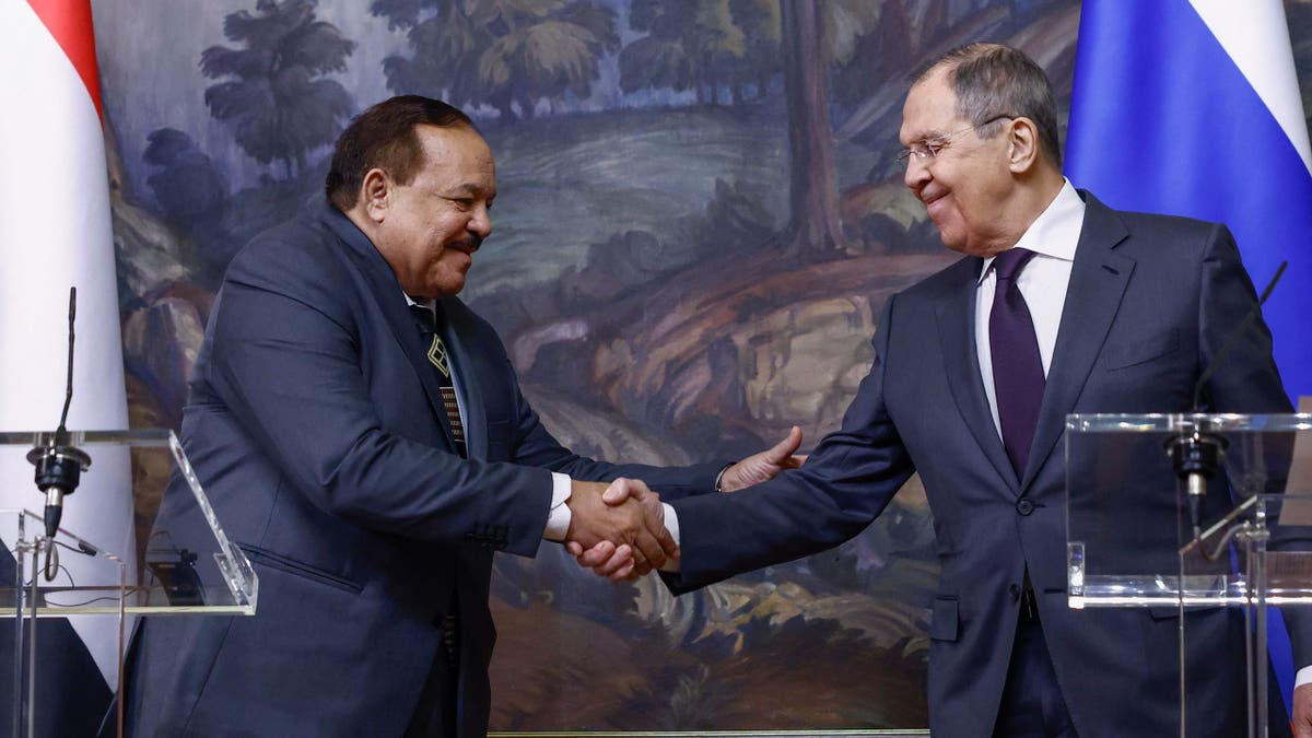 Russian Foreign Minister Sergei Lavrov (R) and his Sudanese counterpart Ali Yousuf Al-Sharif shake hands