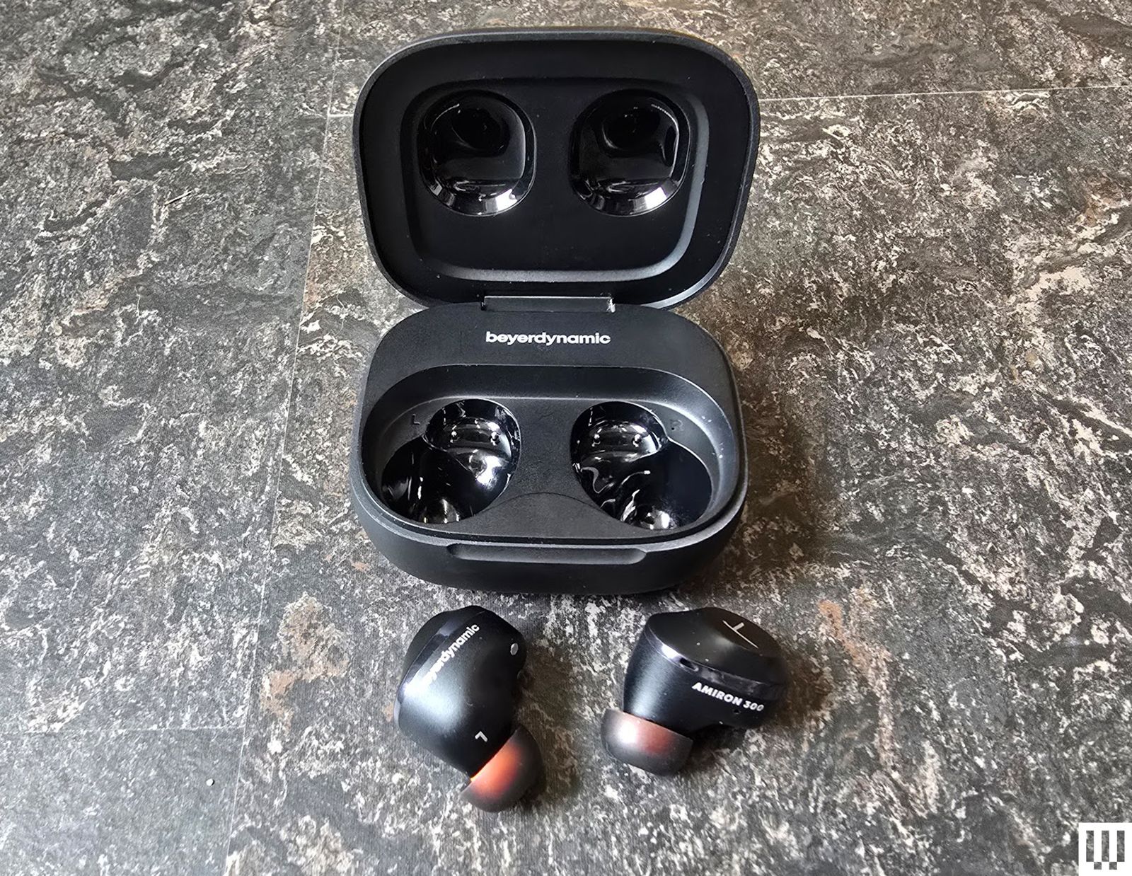 Beyerdynamic Amiron open case with earbud lose on marble table