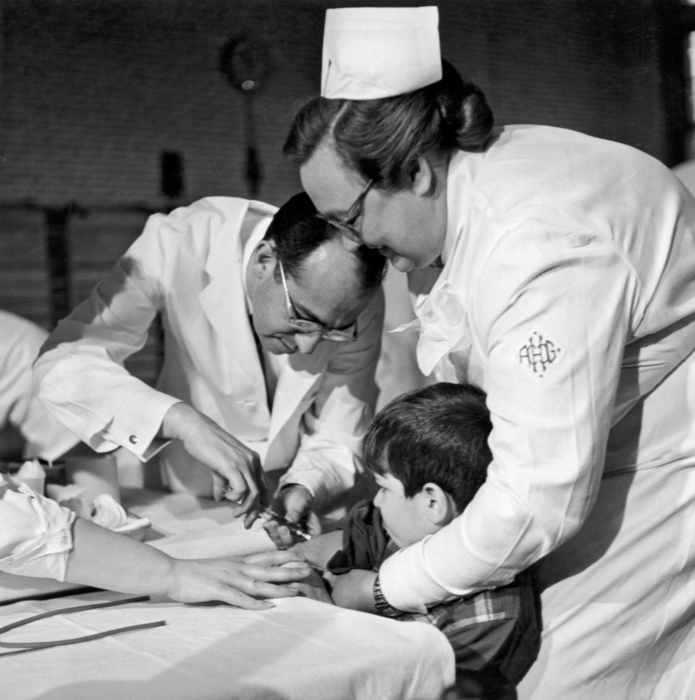 Boy receives trail polio vaccine.