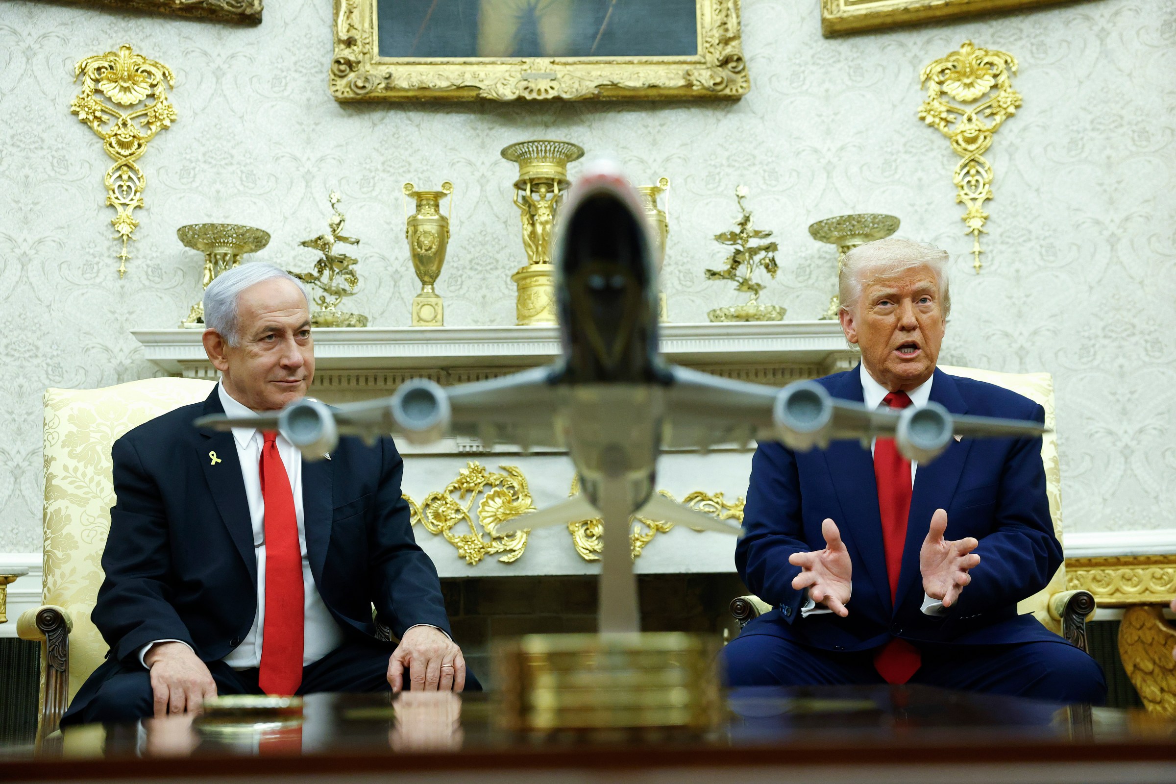 President Donald Trump, right, speaks alongside Israeli Prime Minister Benjamin Netanyahu with a model of Air Force One on the table, during a meeting in the Oval Office on April 7.