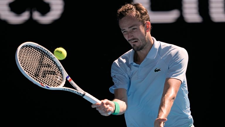 Daniil Medvedev of Russia plays a forehand return to Kasidit Samrej of Thailand during their first round match at the Australian Open tennis championship in Melbourne, Australia, Tuesday, Jan. 14, 2025. (AP Photo/Ng Han Guan)