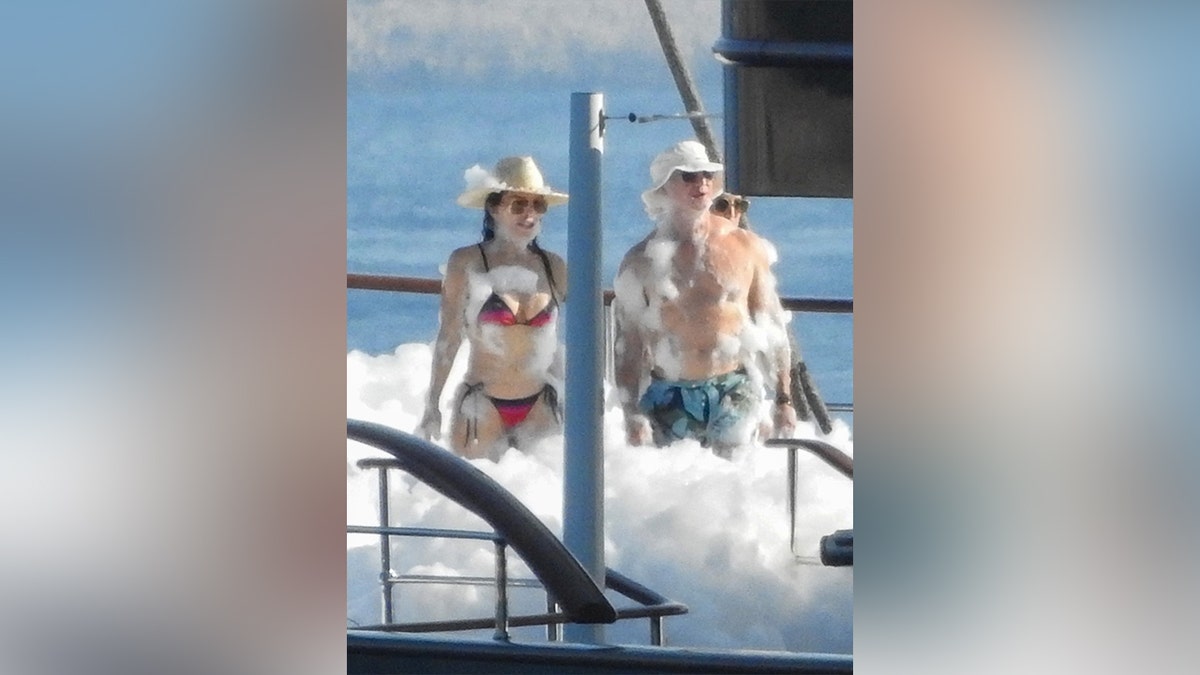 Jeff Bezos and Lauren Sanchez in bathing suits enjoying a foam party on his yacht.