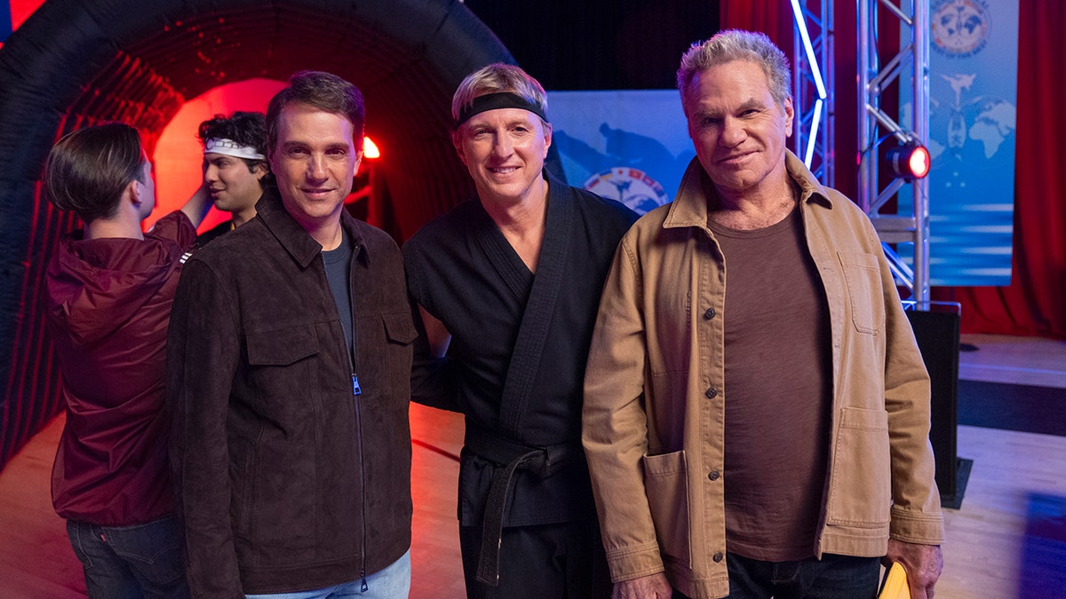Ralph Macchio, William Zabka and Martin Kove posing together.