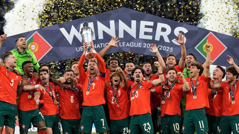 Portugal captain Cristiano Ronaldo lifts the Nations League trophy with his team-mates