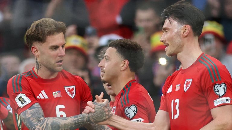 Wales' defender Joe Rodon celebrates with teammates after scoring the first goal during the match between Wales and Liechtenstein