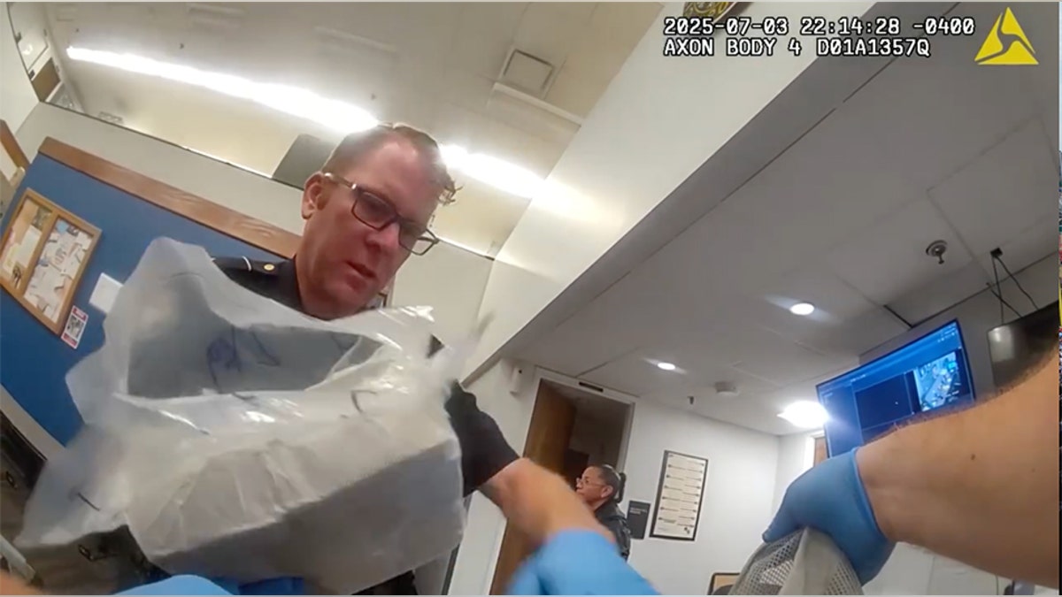 Atlanta Police Department officer looking at luggage