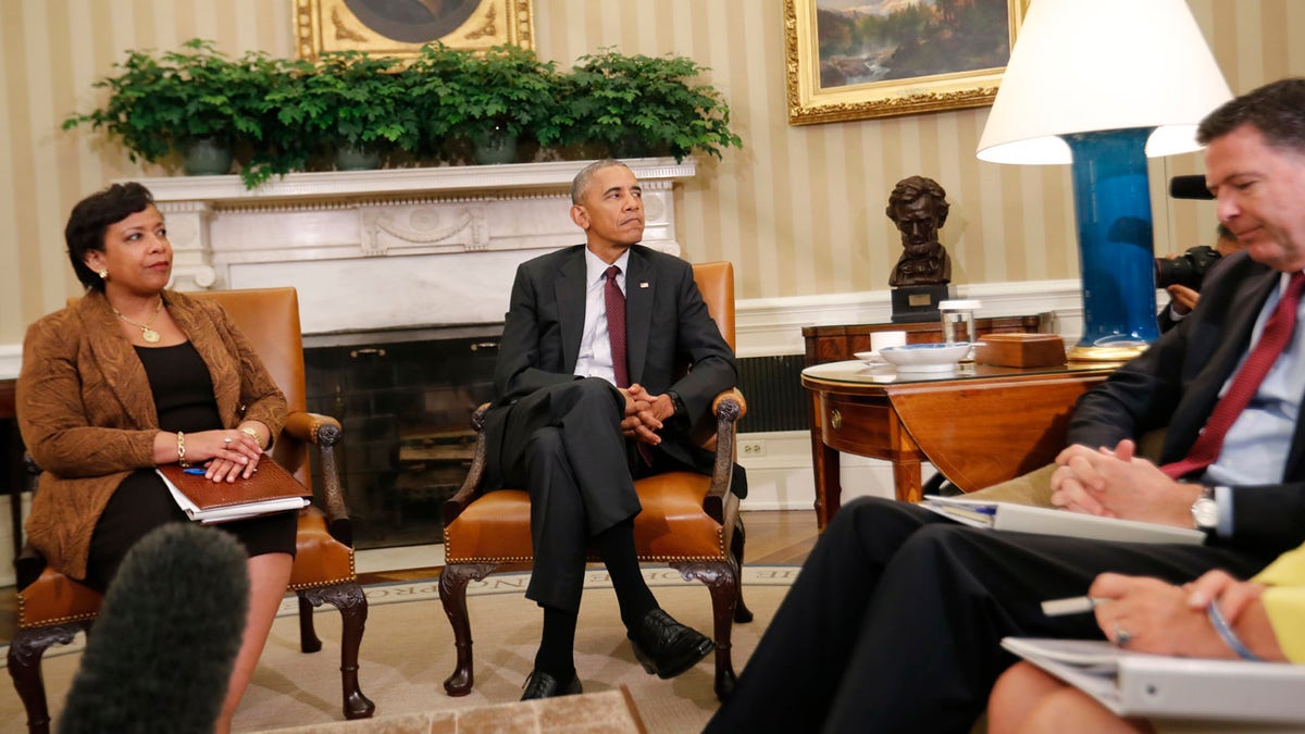 President Barack Obama, center, with Attorney General Loretta Lynch, left, and FBI Director James Comey, right, sit during their meeting in the Oval Office of the White House in Washington, Tuesday, July 19, 2016. (AP Photo/Pablo Martinez Monsivais)
