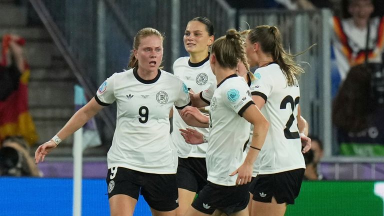 Germany's Sjoeke Nuesken, left, celebrates after scoring her side's first goal during the Women's Euro 2025 quarterfinals soccer match between France and Germany at St. Jakob-Park in Basel, Switzerland, Saturday, July 19, 2025. (AP Photo/Alessandra Tarantino)