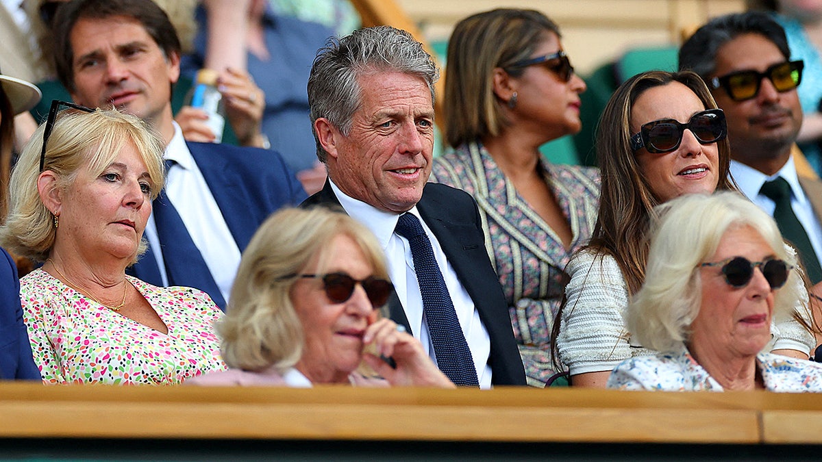 Hugh Grant at Wimbledon, sitting behind Queen Camilla