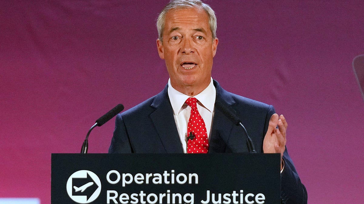 British Reform party leader Nigel Farage at a podium speaking about mass migration. 