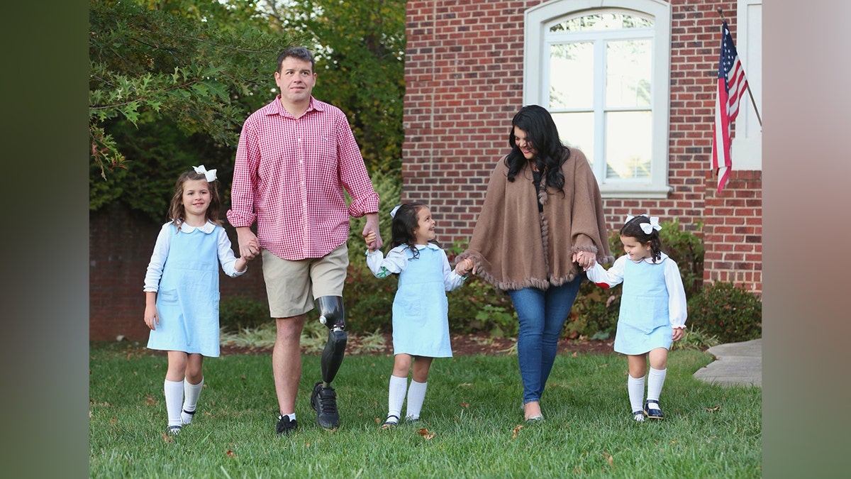 Michael Verardo with prosthetic leg walked hand in hand with wife Sarah and their three daughters near their home.