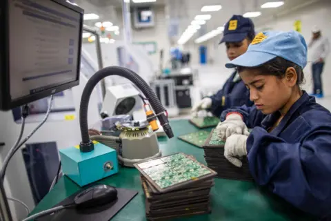 Getty Images Employees work on the SMT (surface mount technology) shop floor where components are mounted on a PCB (printed circuit board) at Padget Electronics Pvt., a subsidiary of Dixon Technologies Ltd., in Noida, India.