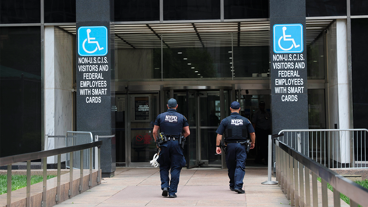 Members of the NYPD Strategic Response Group enter 26 Federal Plaza