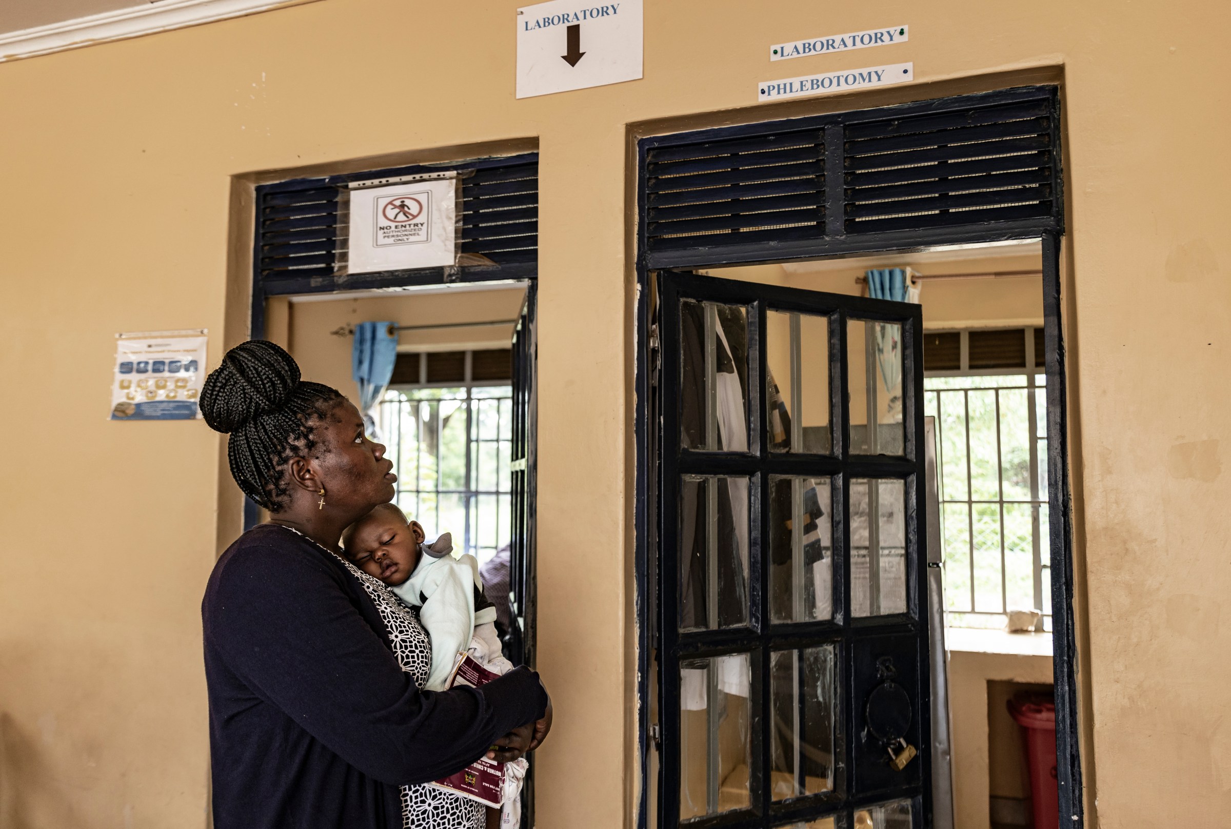 A mother living with HIV since 2017 visits Kuoyo Sub-county Hospital with her child to collect their medications, on April 24, 2025 in Kisumu, Kenya.
