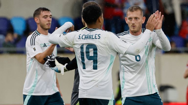 Shea Charles celebrates with his teammates after scoring against Luxembourg (AP Photo/Geert Vanden Wijngaert)