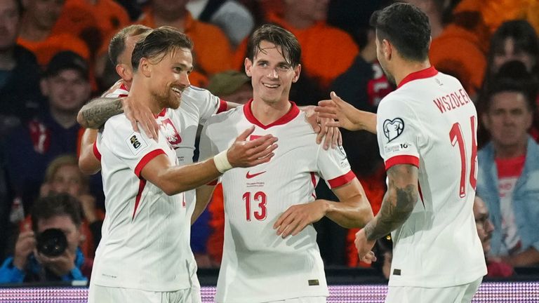 Polish players celebrate with Matt Cash after his equaliser against the Netherlands (AP Photo/Peter Dejong)