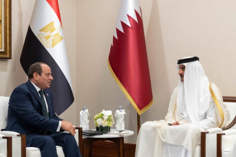 This handout picture released by the he Qatar News Agency (QNA) shows Qatar's Emir Sheikh Tamim bin Hamad Al-Thani (Right) meeting with Egypt's President Abdel Fattah al-Sisi on the sidelines of the 2025 Arab-Islamic emergency summit in Doha on September 15, 2025. Arab and Muslim leaders called for a review of ties with Israel after emergency talks in Doha on September 15 following last week's deadly strike on Hamas members in the Qatari capital. (Photo by Qatar News Agency / AFP) / RESTRICTED TO EDITORIAL USE - MANDATORY CREDIT "AFP PHOTO / QATAR NEWS AGENCY " - NO MARKETING NO ADVERTISING CAMPAIGNS - DISTRIBUTED AS A SERVICE TO CLIENTS