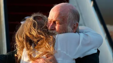 AFP via Getty Images Peter Reynolds also hugs his daughter