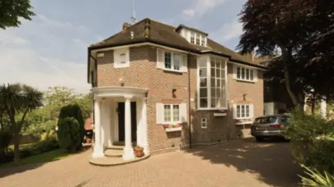 Crown Prosecution Service The large home in North London that Jian Wen moved into in 2017. The picture shows a three-storey house with an expansive driveway. A grey car is parked next to the house, which has multiple large windows.