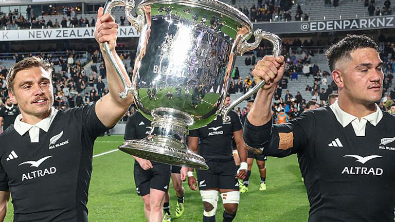 New Zealand's Cortez Ratima (L) and Quinn Tupaea (R) hold up the Bledisloe Cup after their victory against Australia