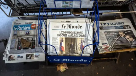 EPA Newspapers with headlines reflecting the political crisis