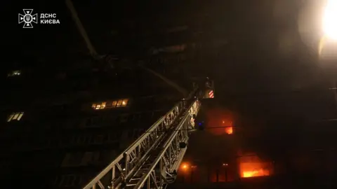 Reuters A firefighter crane putting out a blaze in Ukraine's capital Kyiv