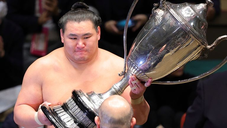 Hoshoryu Tomokatsu of Mongolia lifts the trophy after winning the Tokyo Grand Sumo Tournament (Associated Press)
