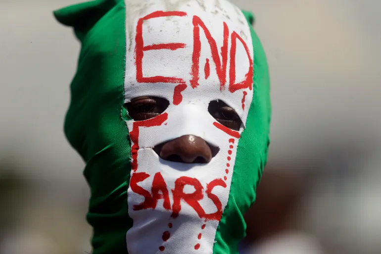 FILE - In this Oct. 18, 2020, file photo, a protester participates in a demonstration against a police unit known as the Special Anti-Robbery Squad, or SARS, at Lekki toll plaza in Lagos, Nigeria. The protests faced widespread accusations of brutality, unwarranted arrests and bribery. It climaxed on Oct. 20, 2020 when protesters were killed nationwide, according to Amnesty International's Nigerian office. (AP Photo/Sunday Alamba, File)