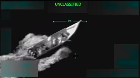 Donald Trump/Truth Social A screengrab from the video posted by Donald Trump allegedly showing a "drug boat" sailing in the Caribbean. The footage is grainy, but clearly shows a boat with a number of people onboard. 