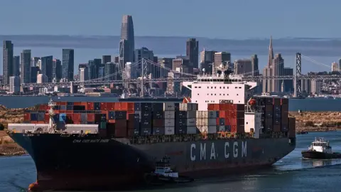 Getty Images In an aerial view, a container ship arrives at the Port of Oakland on October 10, 2025 in Oakland, California. U.S. President Donald Trump is threatening to impose a massive increase of tariffs on Chinese imports in response to China's announcement of new export controls on rare earths. 