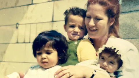 Photo supplied An Iranian adoptee who requested anonymity, bottom left, as a child.