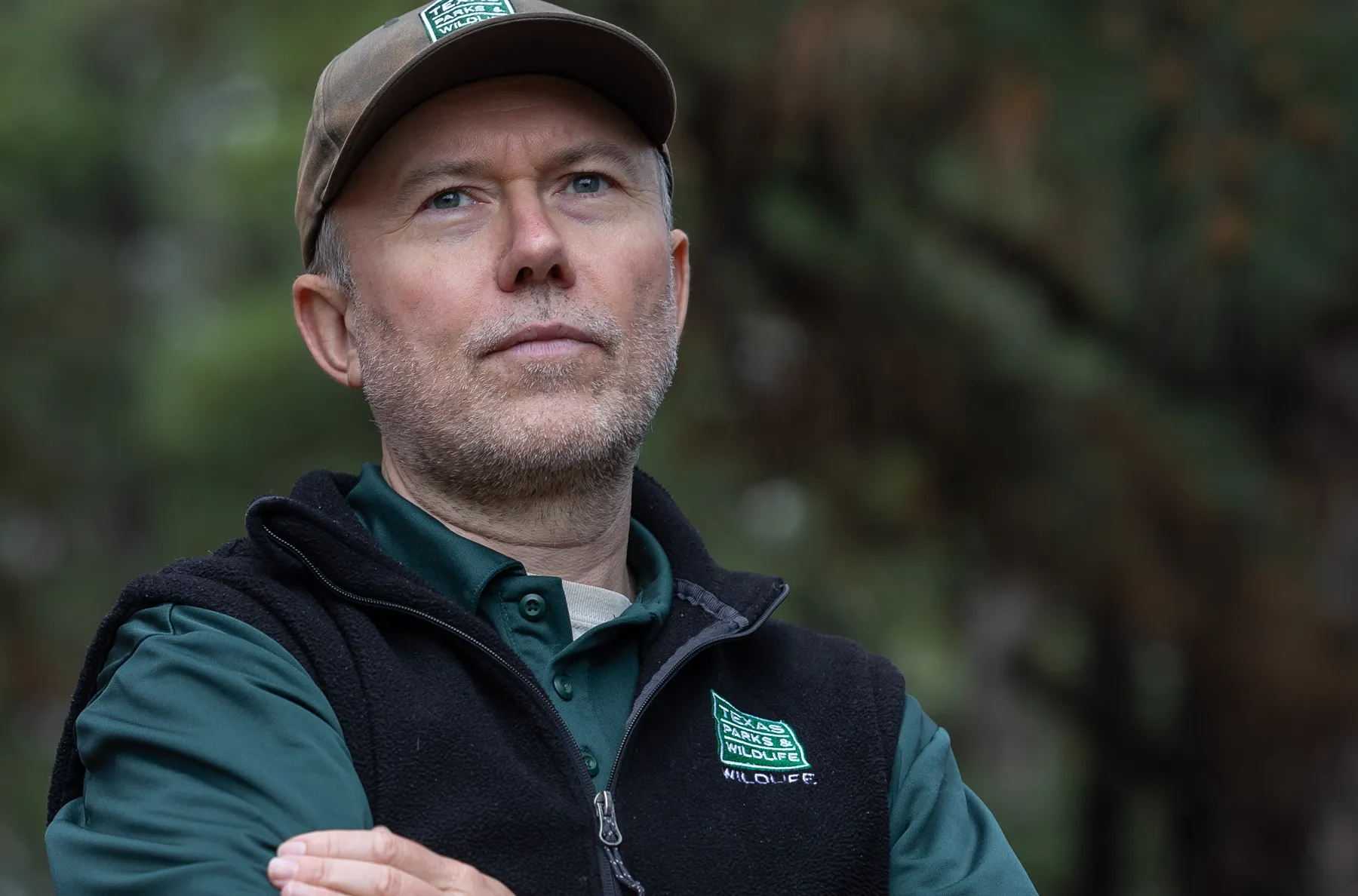 An older man wearing a Texas Parks and Wildlife vest