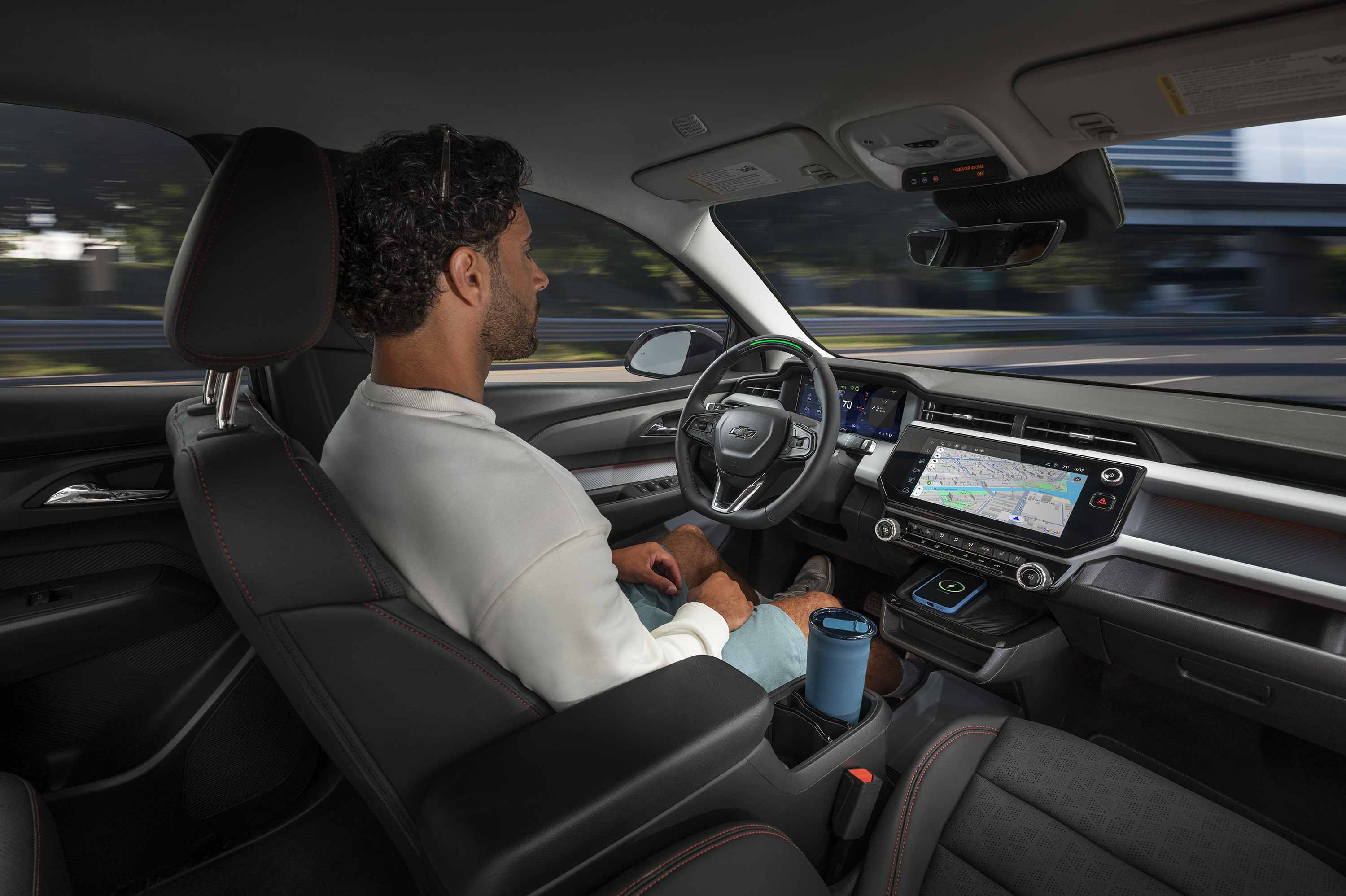 A man rides in a Chevrolet Bolt and uses super cruise