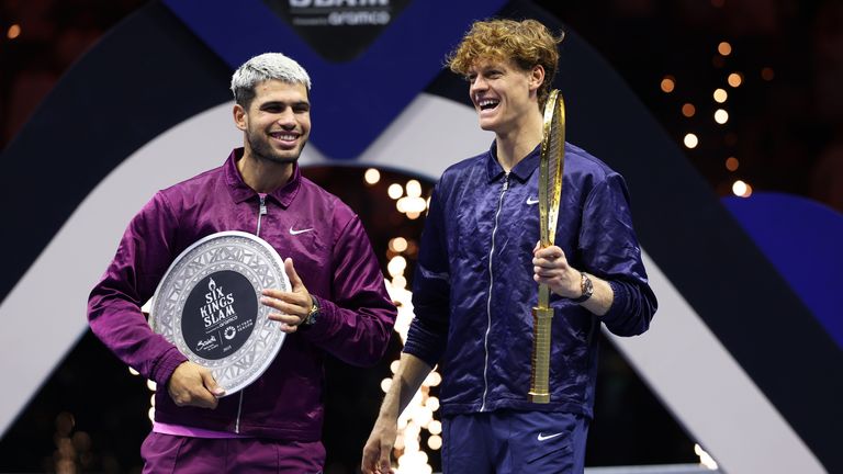 Jannik Sinner of Italy (R) and Carlos Alcaraz of Spain share a joke after receiving their trophies after the Men's Single's Final on day thr