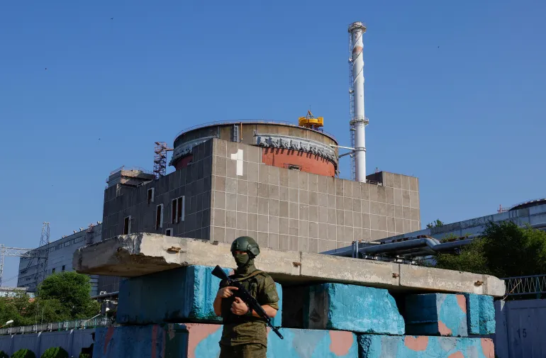 A Russian service member stands guard at a checkpoint near the Zaporizhzhia Nuclear Power Plant [FILE: Alexander Ermochenko/Reuters]