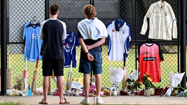 Mourners pay tribute at cricket nets after the death of Australian cricketer Ben Austin