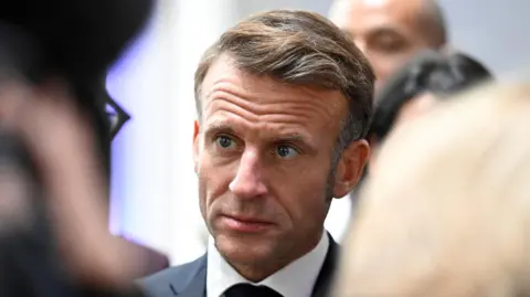 Reuters A headshot of Emmanuel Macron looking serious